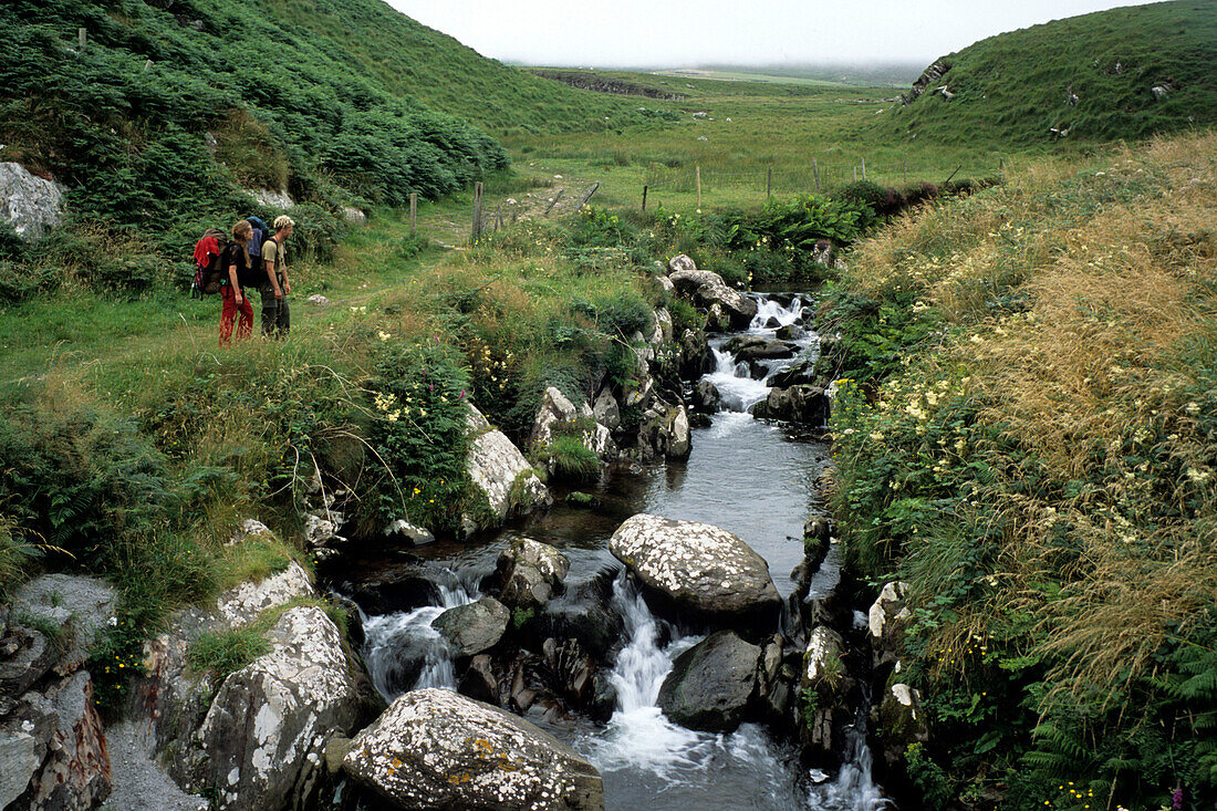 Hikers at Brandon Creek, Dingle Peninsula, near Brandon, County Kerry, Ireland