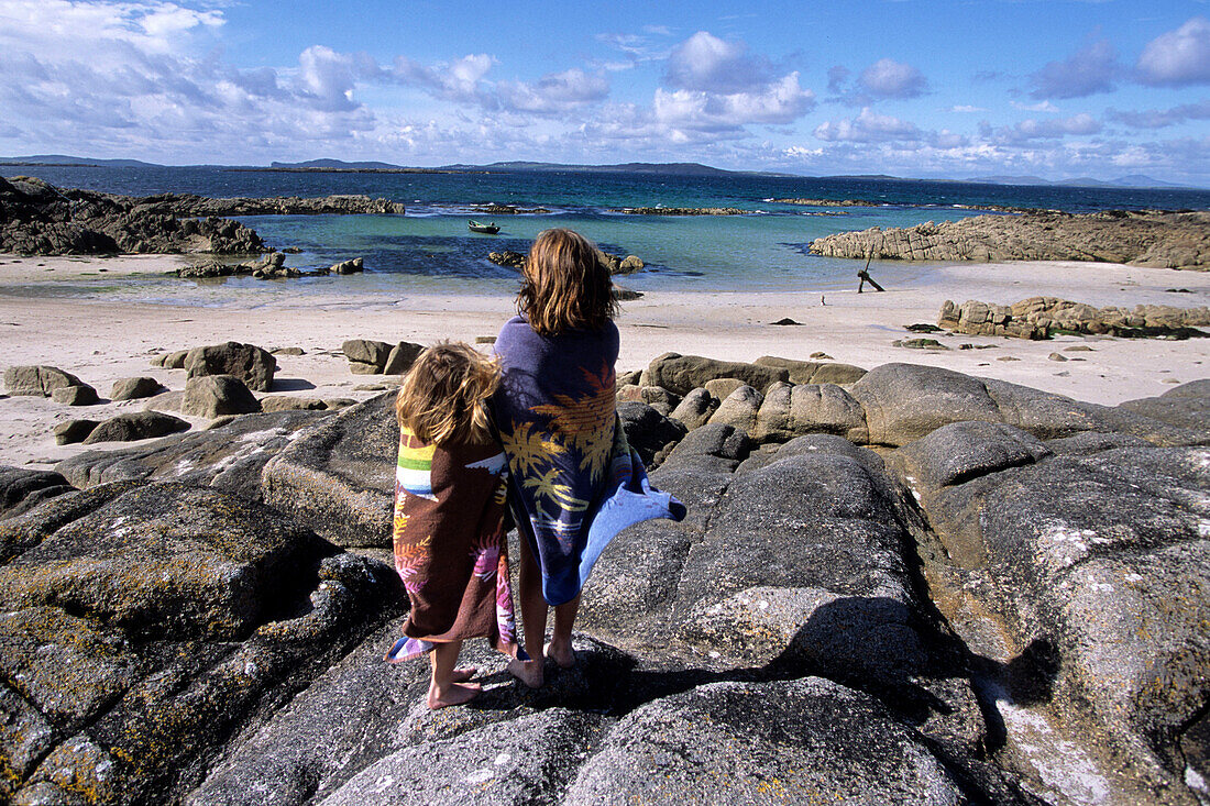 Zwei Mädchen in Handtüchern am Aughrusbeg Beach, Connemara, County Galway, Irland