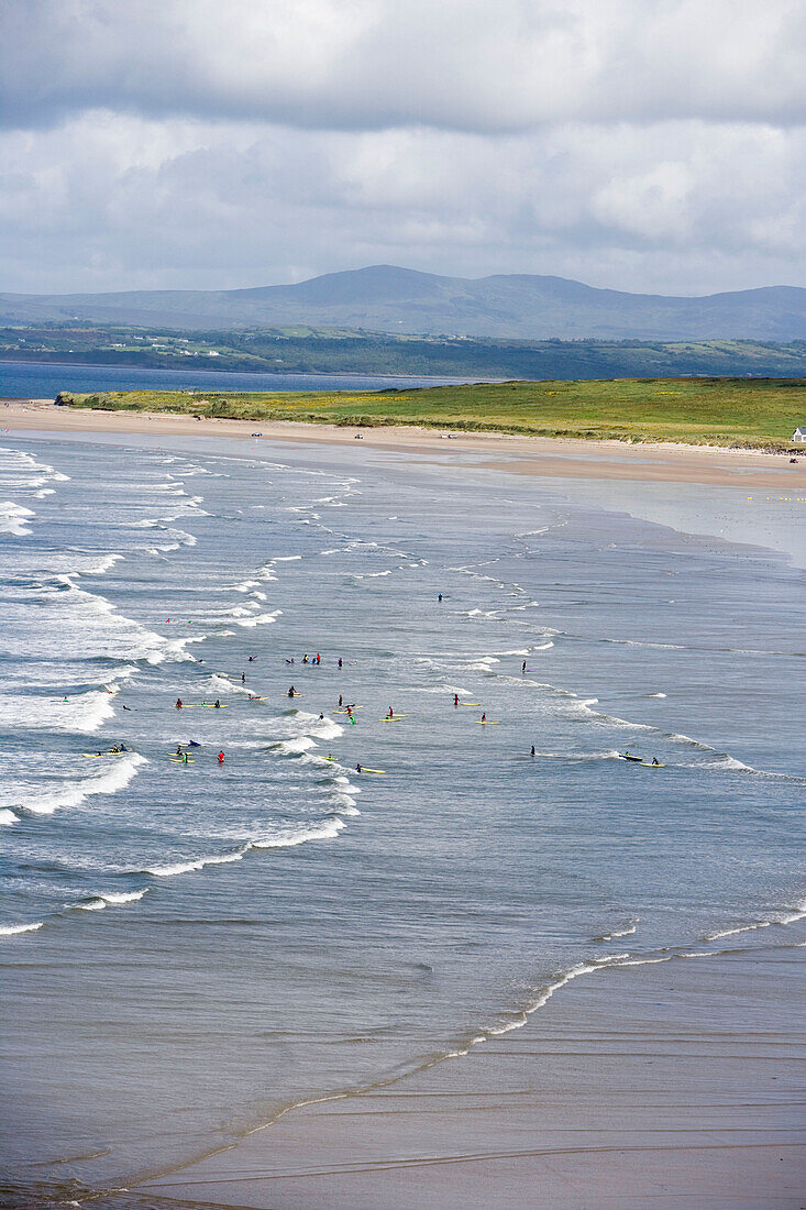 Surfen auf den Rossnowlagh Wellen, gesehen vom Smuggler's Creek Inn, County Donegal, Irland