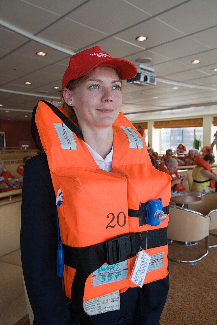 MS Bremen Crewmember at Compulsory Lifesaving Drill, Aboard MS Bremen Cruise Ship, Hapag-Lloyd Kreuzfahrten, Germany