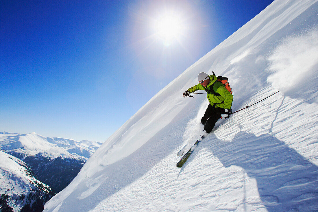 A young man skiing down a steep slope from the mountain Popova Kapa, Rila Mountains, Bulgaria, Europa
