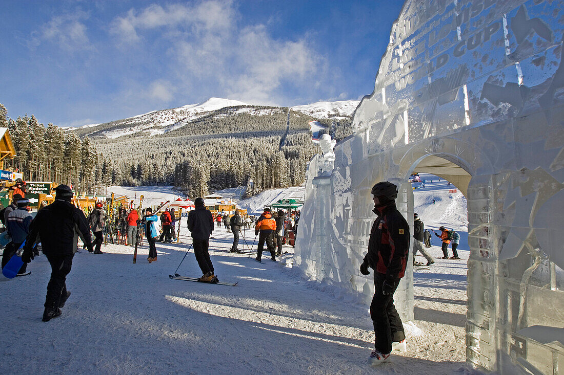 Ein Mann läuft durch eine Eisskulptur bei der Talstation von Lake Louise. Sie wurde anlässlich des Weltcuprennens und Saisonstart 2005 gebaut, Banff, Lake Louise, Rocky Mountains, Alberta, Kanada, Nord Amerika