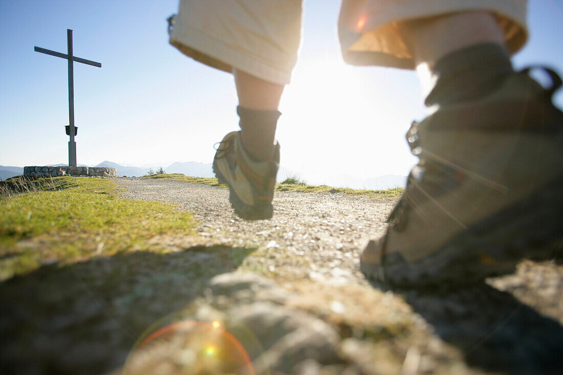 Man walking to the summit of Brauneck mountain, Bavaria, Germany