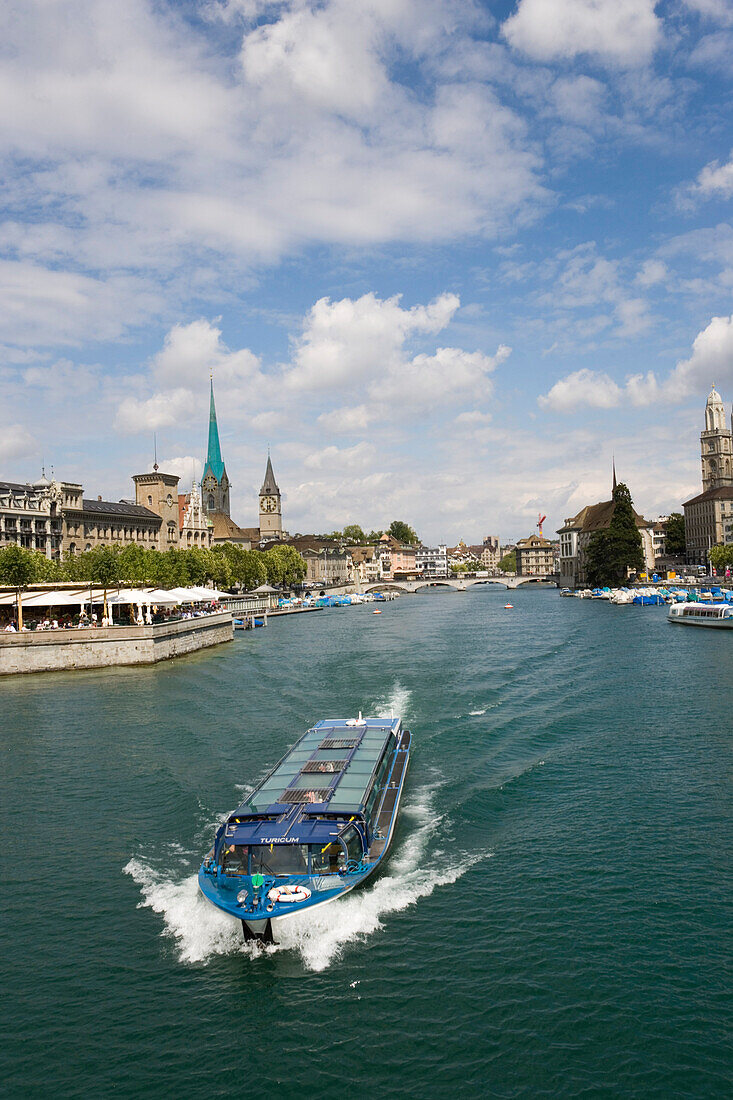 View over river Limmat with excursion boat to Fraumuenster, St. Peter church and Grossmuenster, Zurich, Canton Zurich, Switzerland