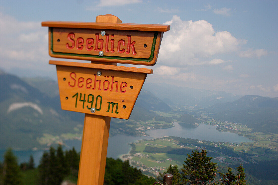 View from the Zwoelferhorn over lake Wolfgangsee with sign in the foreground, Salzburg, Austria