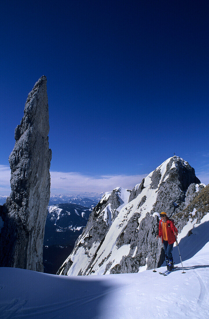 Backcountry skier in front of pinnacle, Gosau range, Dachstein range, Salzburg, Austria