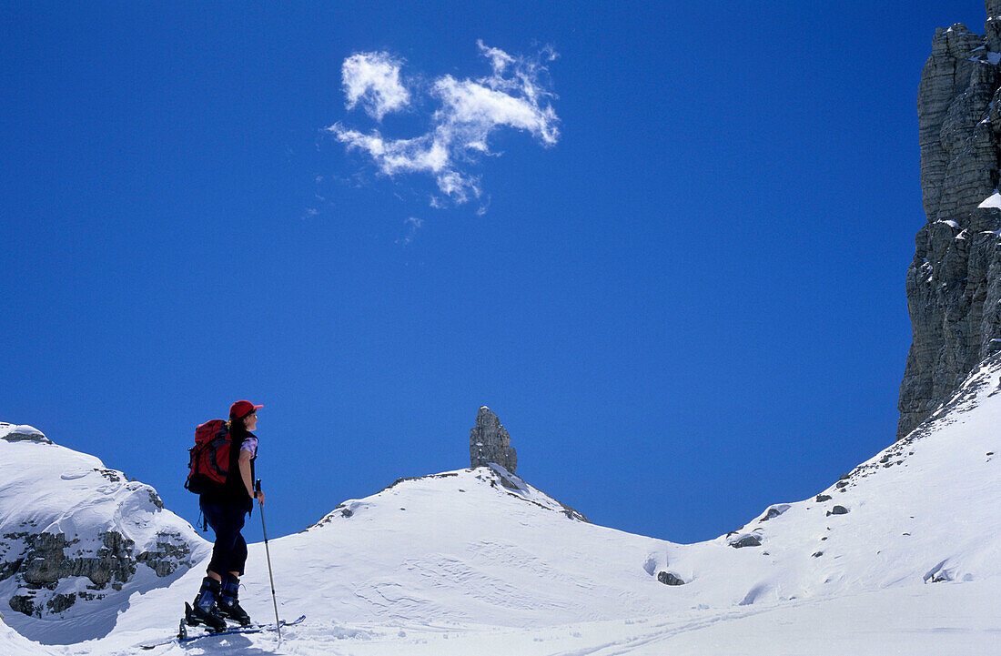 Backcountry skier in front of pinnacle, Cristallo range, Dolomites, South Tyrol, Italy