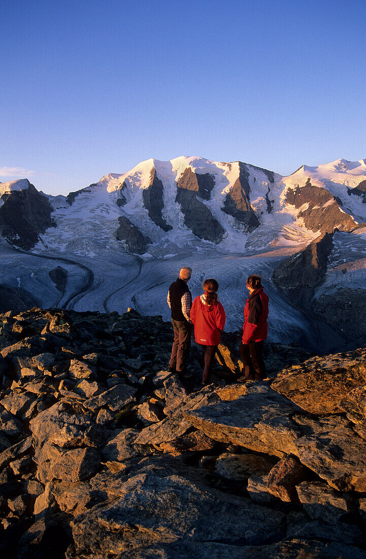 Three mountaineerers in front of Piz Palü and Pers glacier, Bernina, Oberengadin, Grisons, Switzerland