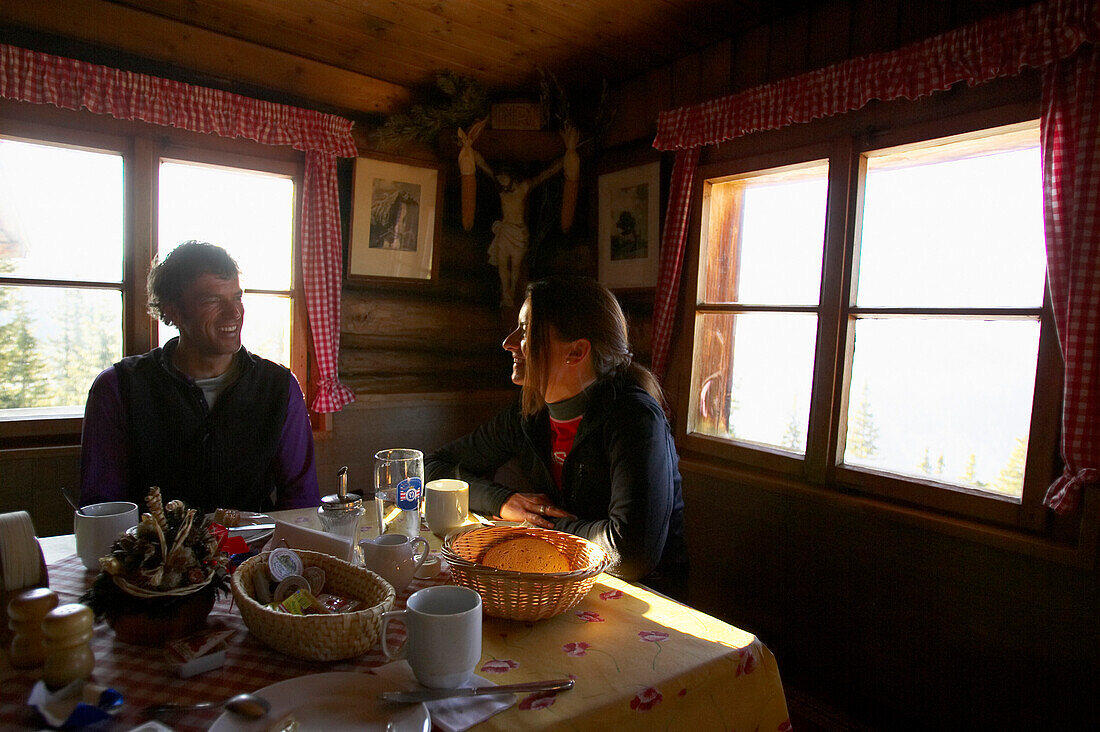 Couple eating breakfast in an alpine hut, Pleissen Hut, Scharnitz, Austria
