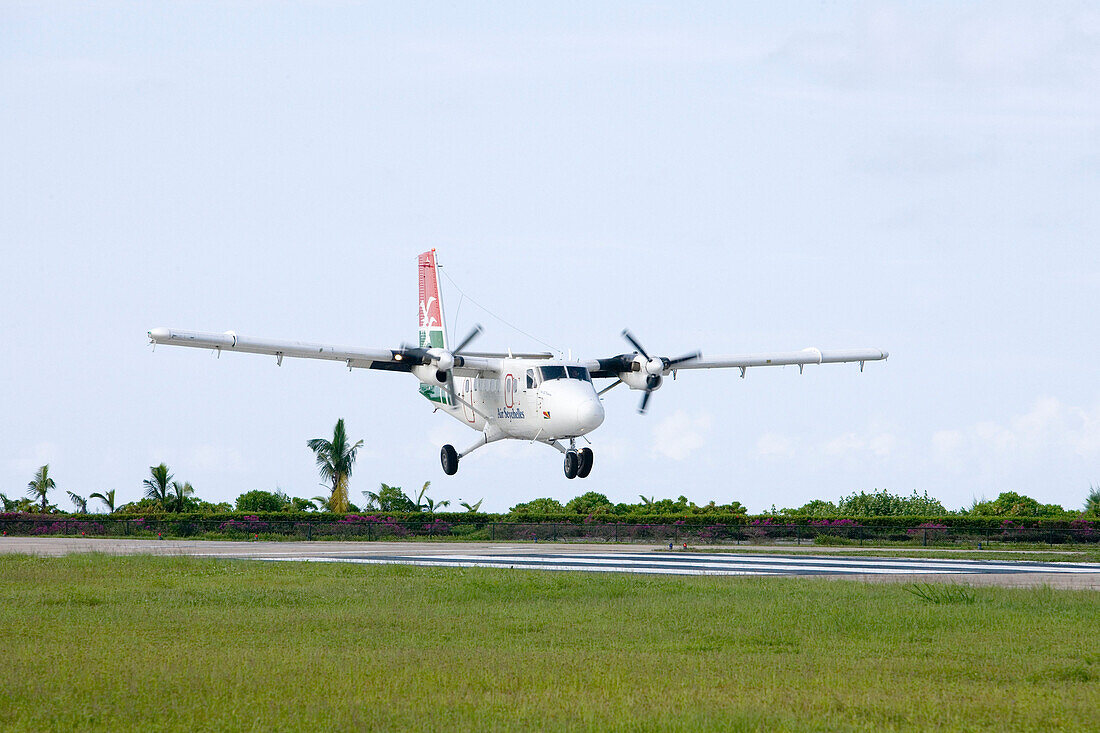 Landing Air Seychelles DHC-6 Twin Otter Airplane,Praslin Airport, Praslin Island, Seychelles