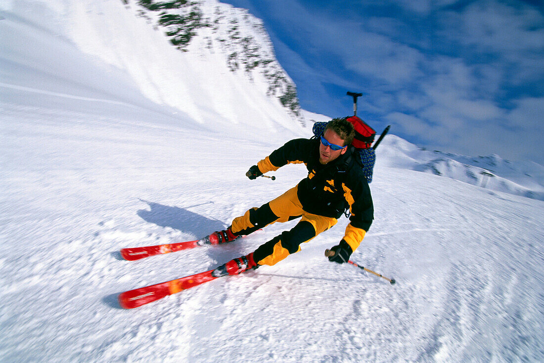 A man skiing downhill after a skitour, Stubai, Tyrol, Austria