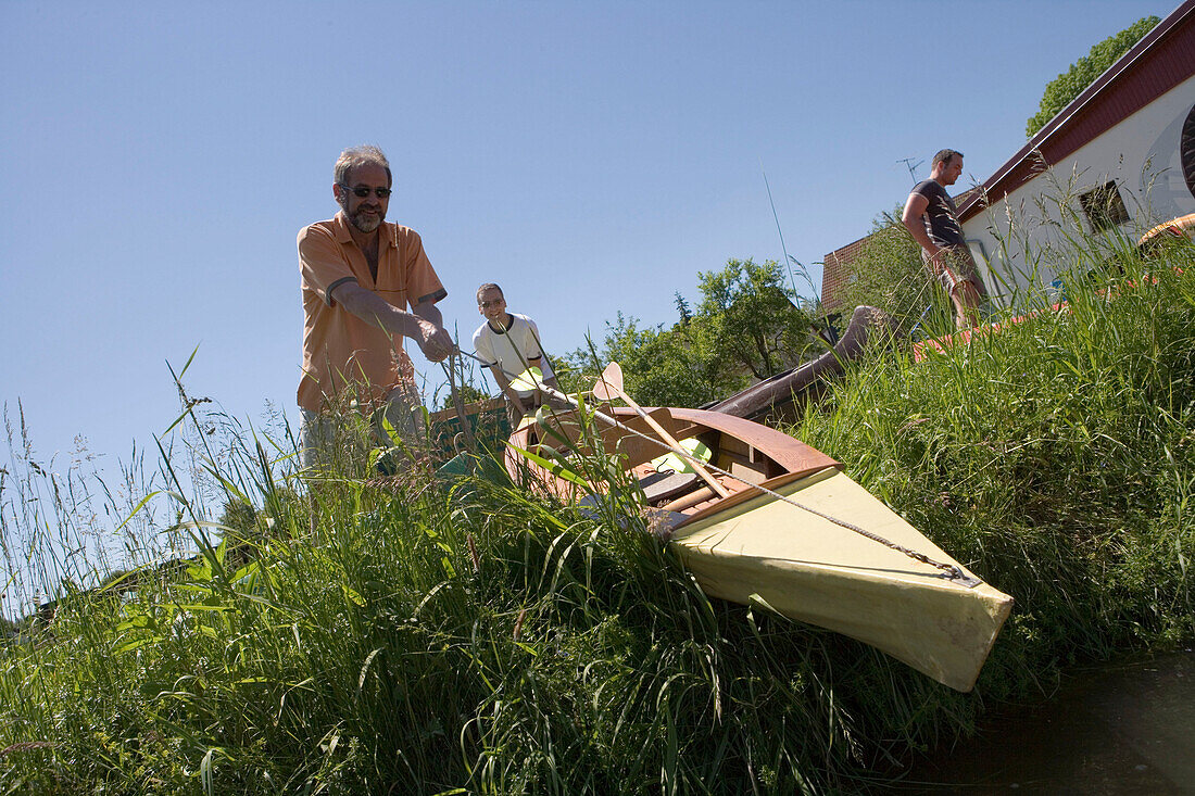 Lowering Canoe into Water, Haunetal-Rhina, Rhoen, Hesse, Germany