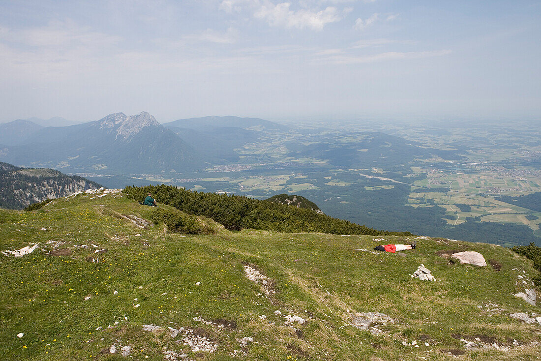 Two people relaxing on a meadow, Untersberg Mountain, near Salzburg, Austria