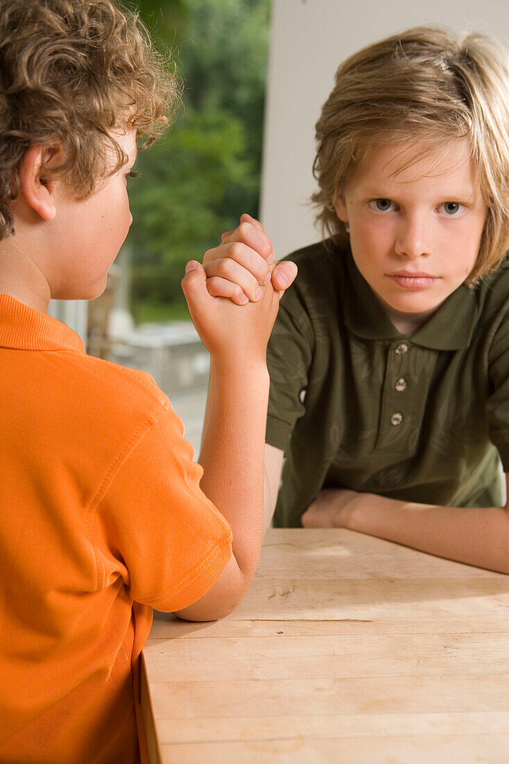 Two boys arm wrestling, children's birthday party