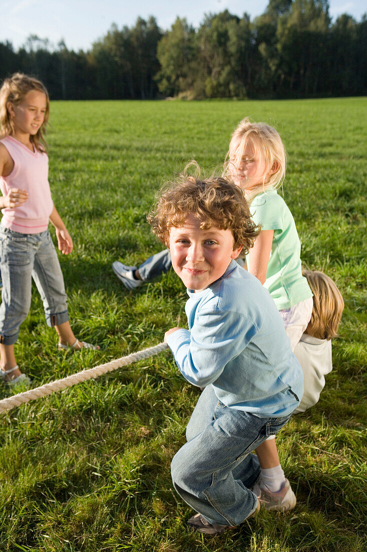 Children playing tug-of-war, children's birthday party