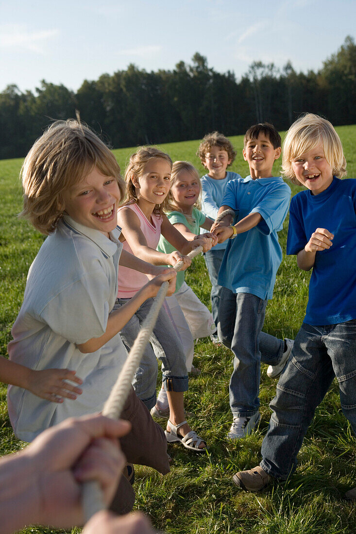 Children playing tug-of-war, children's birthday party