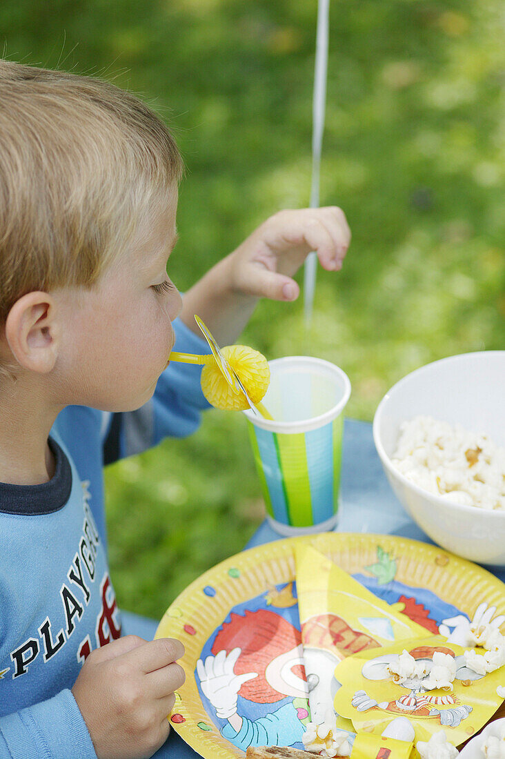 Young boy drinking with straw