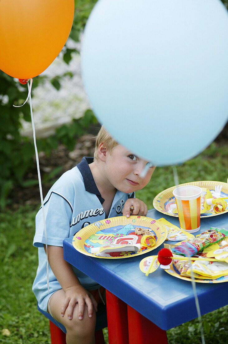 Boy on party table