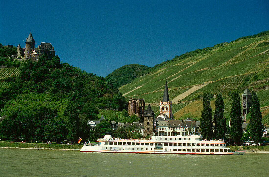 View over River Rhine with excursion boat to Stahleck Castle near Bacharach, Rhineland-Palatinate, Germany