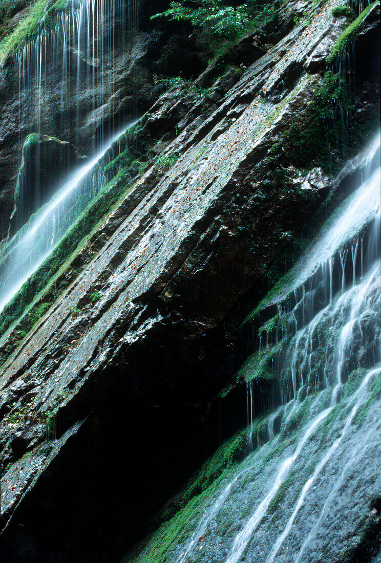 Waterfall against mossy rock, Berchtesgaden National Park, Ramaus, Bavaria, Germany