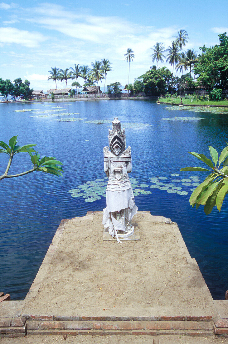 statue in front of sea, candi dasa, bali, indonesia