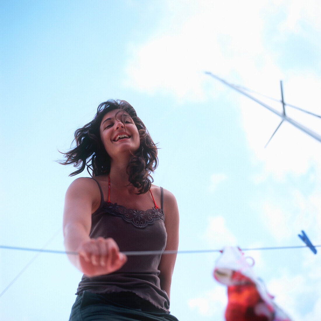 Woman standing on a sailboat and smiling at camera, portrait