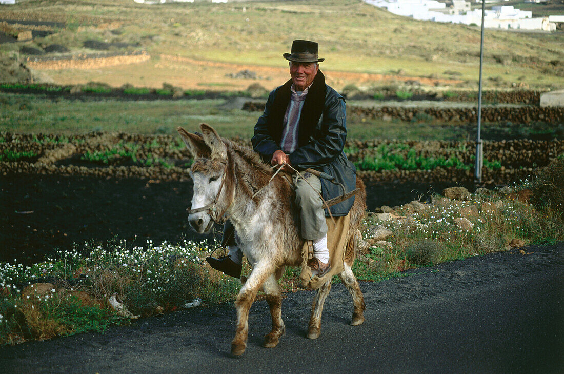 Farmer riding on donkey, La Vegueta, Lanzarote, Canary Islands, Spain