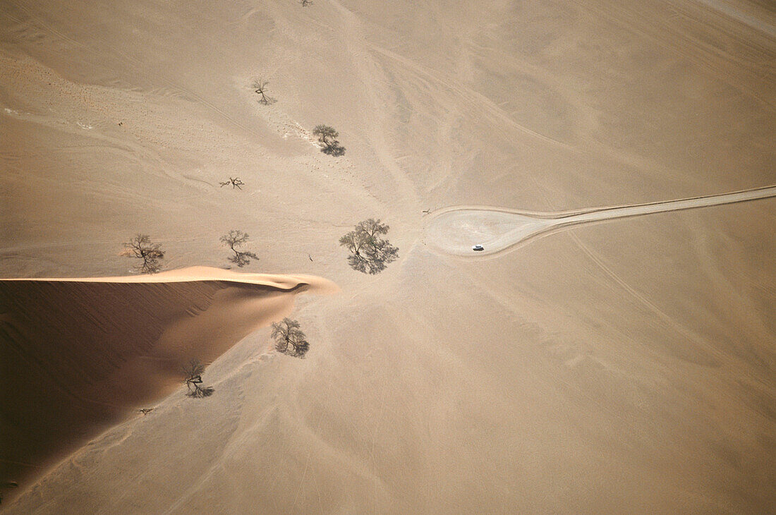 Car at Dune 45, aerial view over Namib Desert, Namibia, Africa