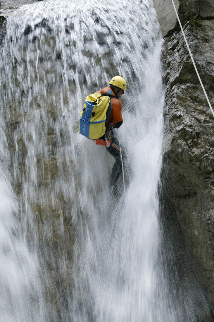 A man abseiling whilst canyoning, Hachleschlucht, Haiming, Tyrol, Austria