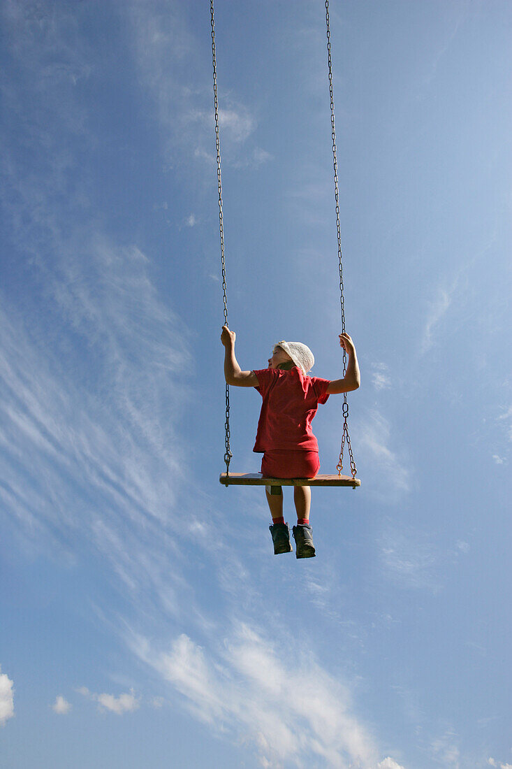 Girl (5-6 years) on a swing