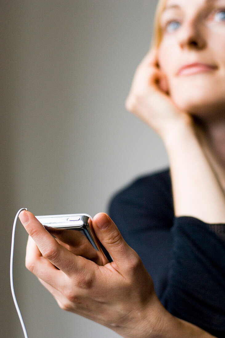 Young woman listening to music about earphones