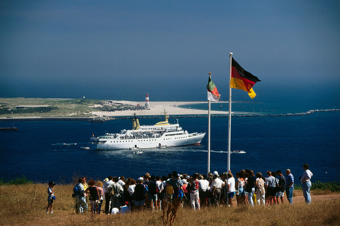 Group of tourists enjoying view over harbour, Helgoland island, Schleswig-Holstein, Germany