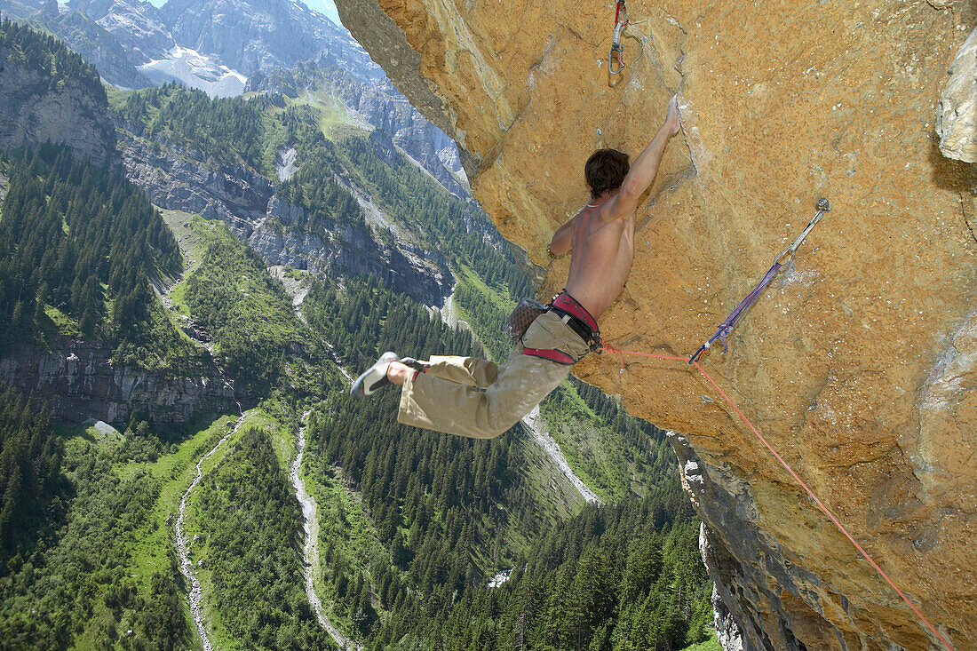Free climber scaling rock face, Gimmelwald, Lauterbrunnen, Canton Bern, Switzerland