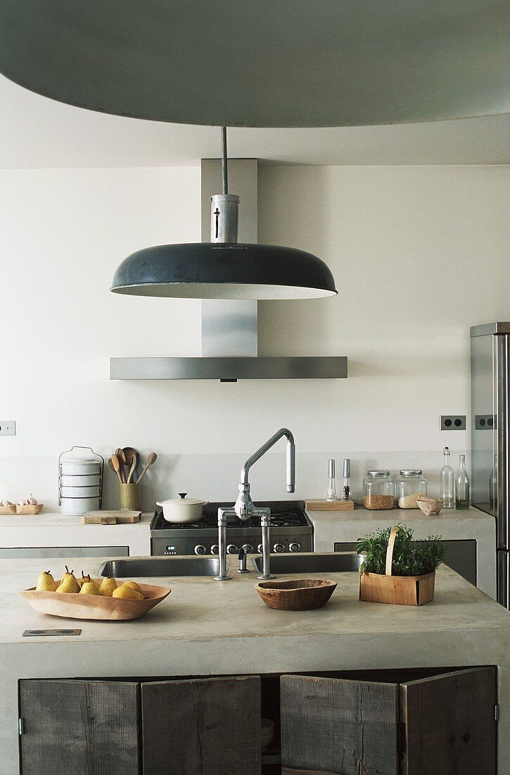 An island counter in a kitchen with a sink