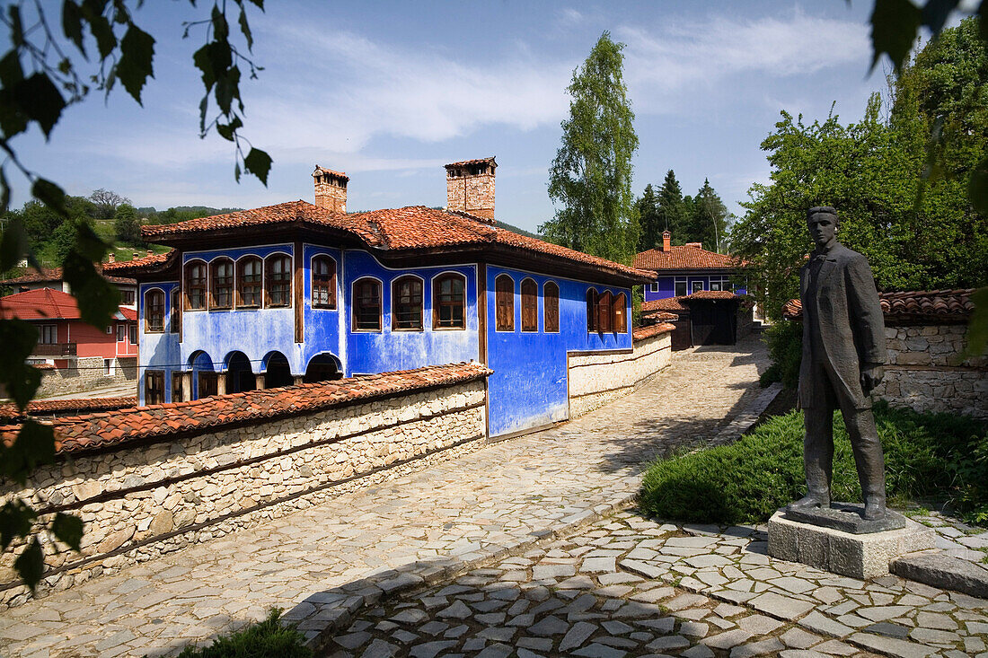 Blue house and statue, museum town Koprivstiza, Bulgaria, Europe