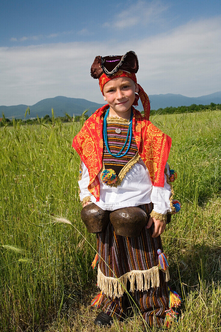 Boy in traditional costume with bells, Rose Festival, Karlovo, Bulgaria, Europe