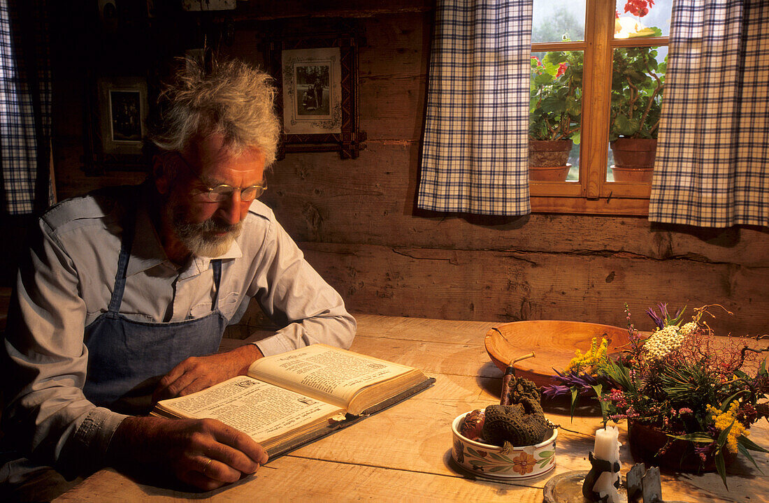 alpine cow boy reeding a historical bible, Gosau, Dachstein range, Upper Austria, Austria