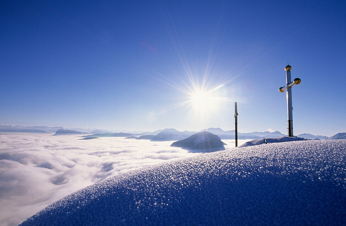 crosses on summit of Kranzhorn with fog down in the valley of Inn, Chiemgau, Upper Bavaria, Bavaria, Germany