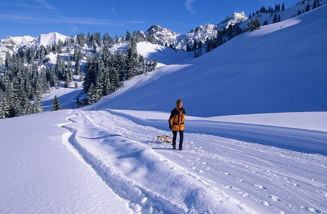 sledging at hut Unterpartnomalpe, Sonnntag, Vorarlberg, Austria