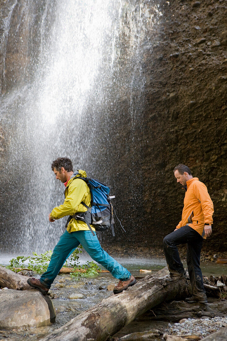 Two men crossing the Necker creek, canyon hike, Ofenloch, Schwaegalp, canton St. Gallen, Switzerland