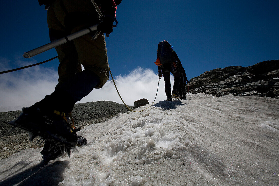 Climber walking over glacier, Pennine Alps, Canton Valais, Switzerland, MR