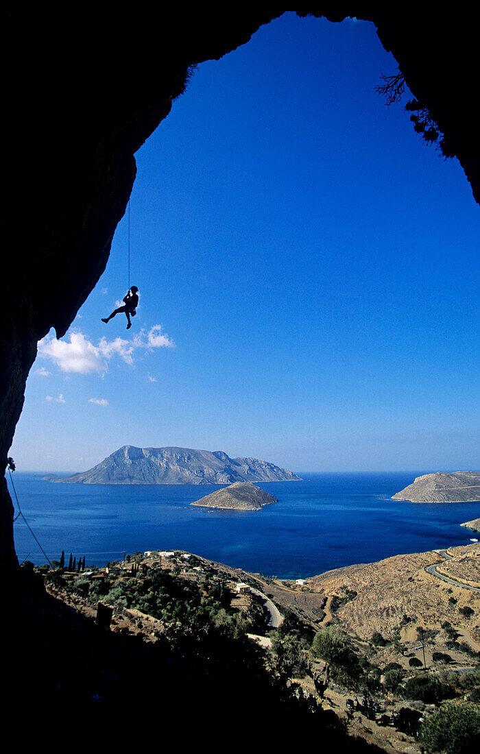 Kalymnos, Greece, Aegean Sea, a climber abseils in a cave above the sea. Kalymnos, Greece, Aegean Sea, Europe