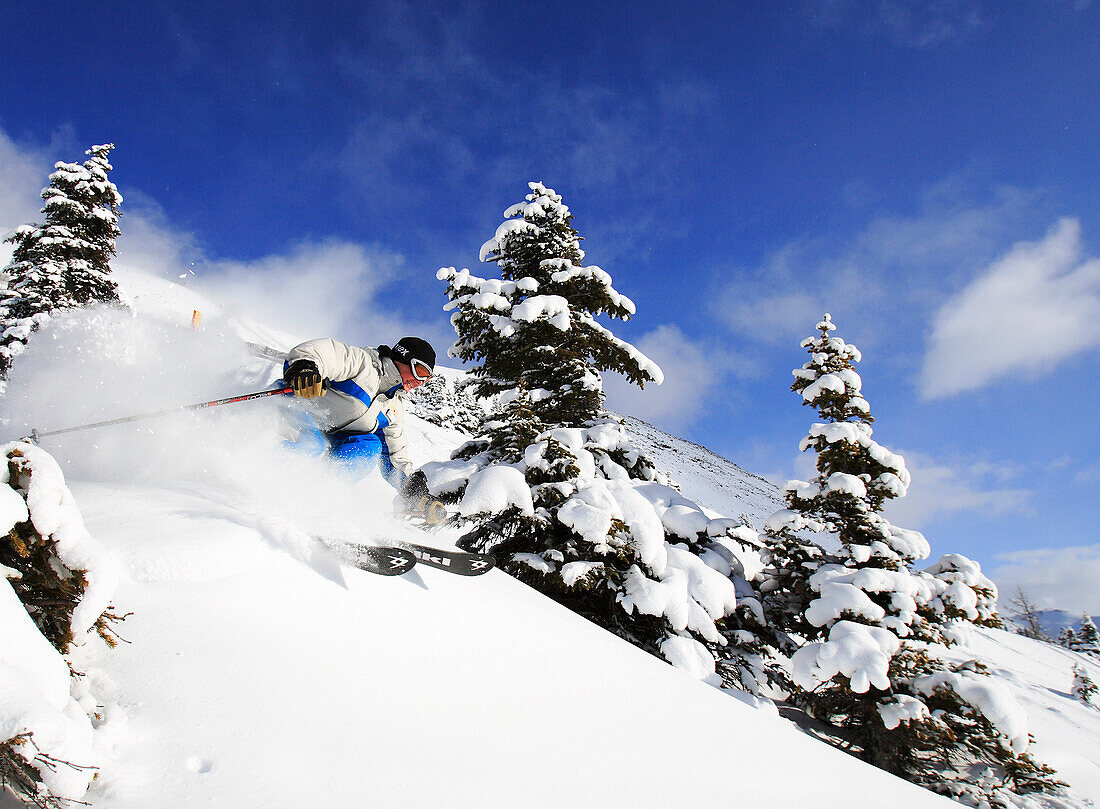 Lake Louise, Banff, a woman skis the powder snow of. Alberta, Rocky Mountains, Canada, North Amerika, MR