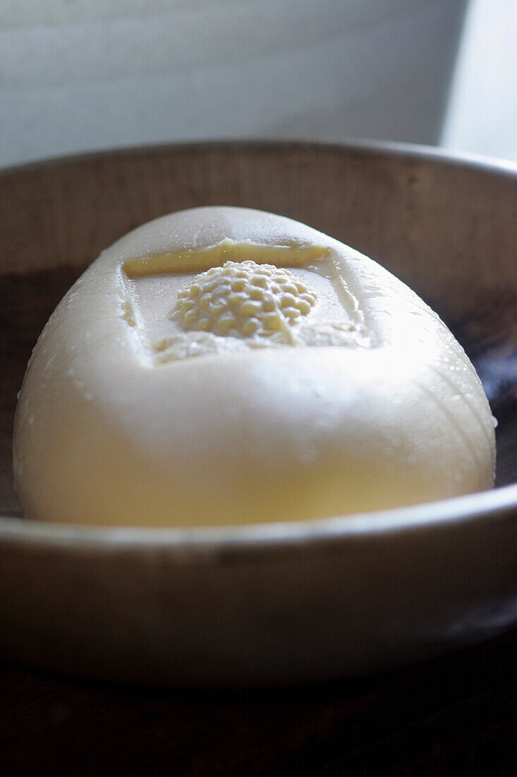 Fresh butter in wooden bowl, close up