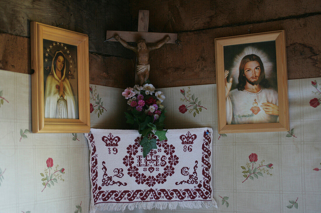 Lords Corner with Cricifix and an embroided Cloth, flanked by Maria and Jesus Pictures