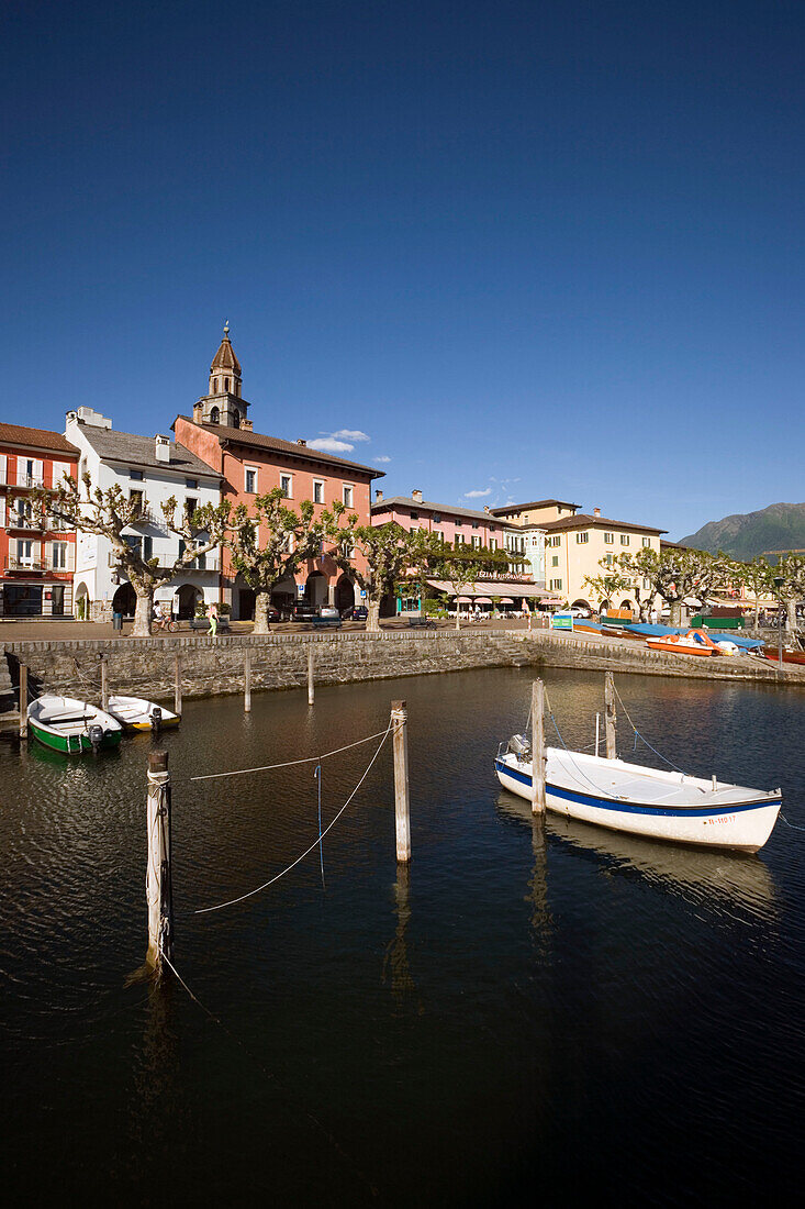 Harbour and harbour promenade with spire of church Santi Pietro Paolo in background, Ascona, Lake Maggiore, Ticino, Switzerland