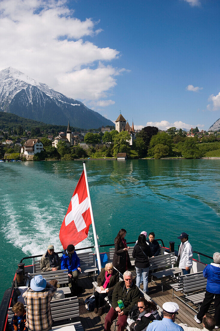 Excursion boat leaving Spiez, view to castle and castle church of Spiez, Lake Thun, Bernese Oberland (highlands), Canton of Bern, Switzerland