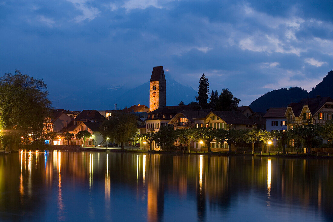 View over river Aare to Unterseen (the highest town on the Aare) at night, Interlaken, Bernese Oberland (highlands), Canton of Bern, Switzerland