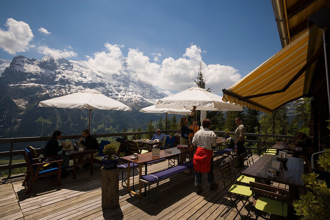 People sitting on terrace of the mountain restaurant Aellfluh, Grindelwald, Bernese Oberland (highlands), Canton of Bern, Switzerland