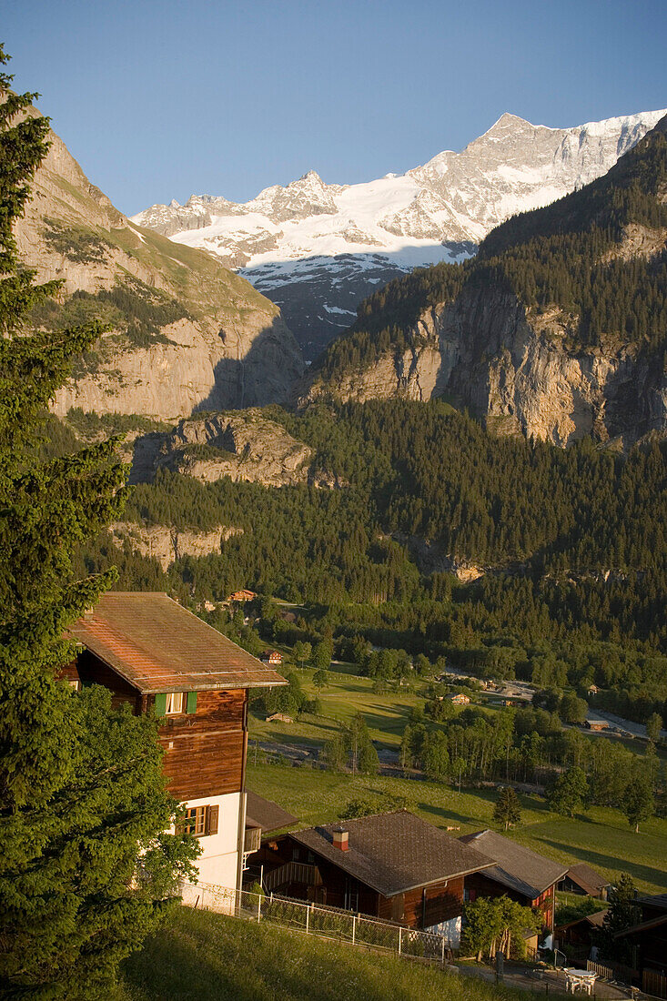 View over a wooden house to Bernese Alps, Grindelwald, Bernese Oberland (highlands), Canton of Bern, Switzerland
